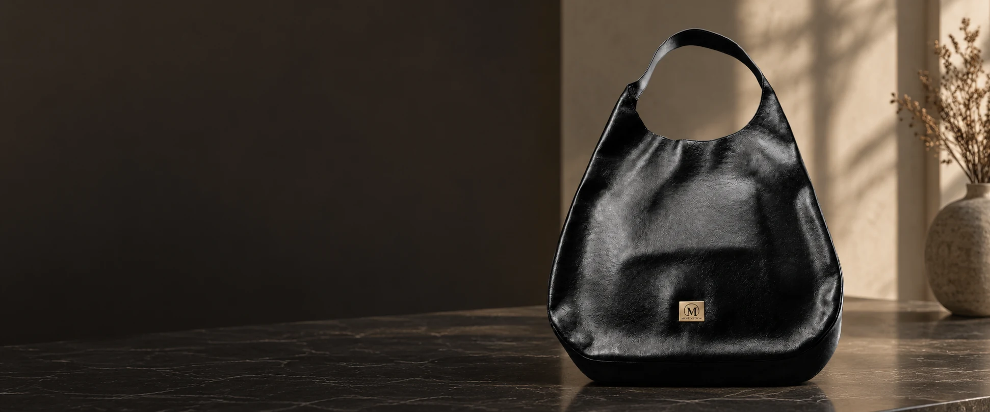 Oversized Leather Hobo Bag displayed on a dark display table in an elegant showroom