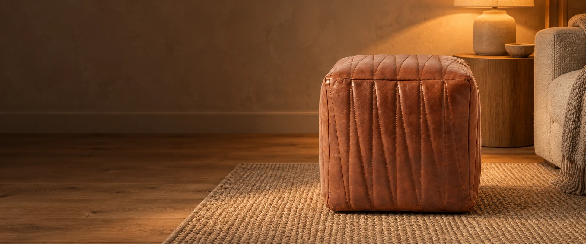 Square Leather Pouf Cover styled in a quiet living room with warm plaster walls and oak floors