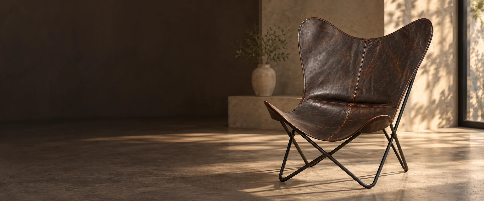 Leather Butterfly Chair Cover styled in a contemporary interior showroom with soft window light