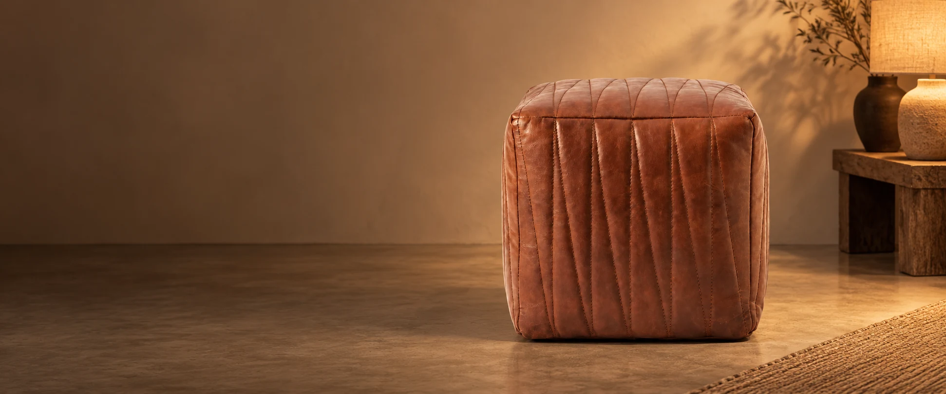 Square Leather Pouf Cover styled in a quiet interior studio with warm ivory walls