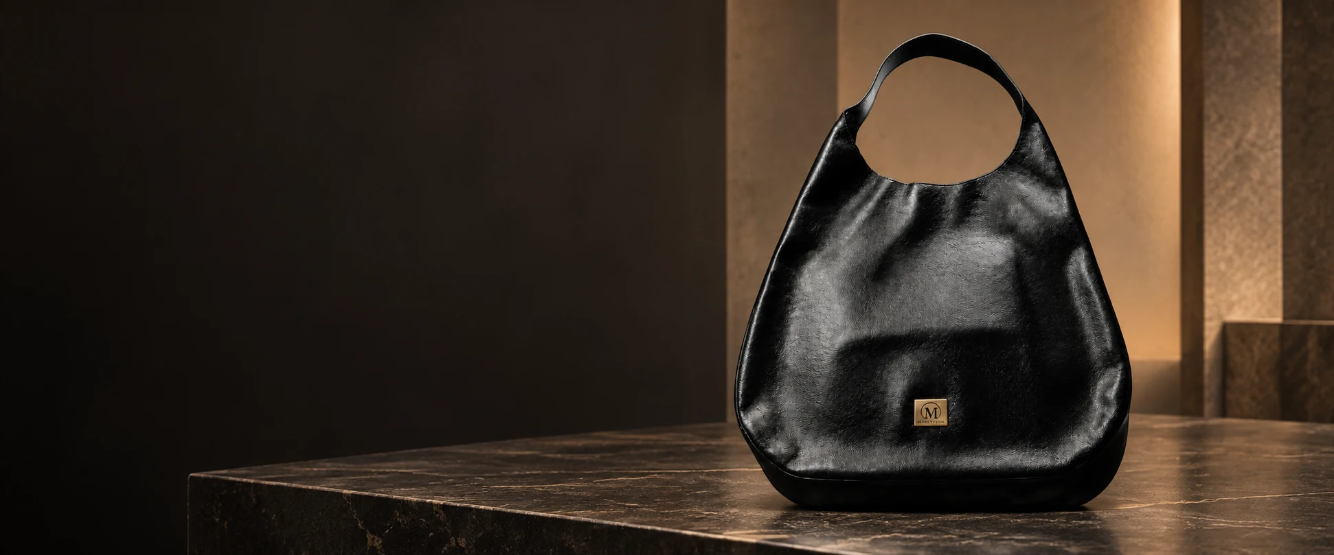 Oversized Leather Hobo Bag displayed on a dark display table in an elegant showroom