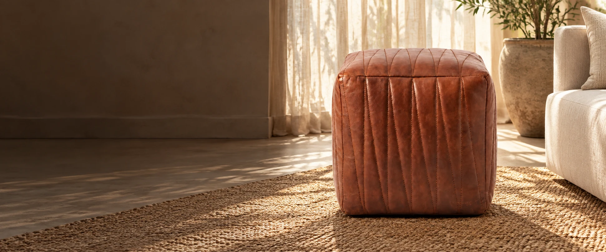 Square Leather Pouf Cover styled in a light-filled living room with woven linen curtains