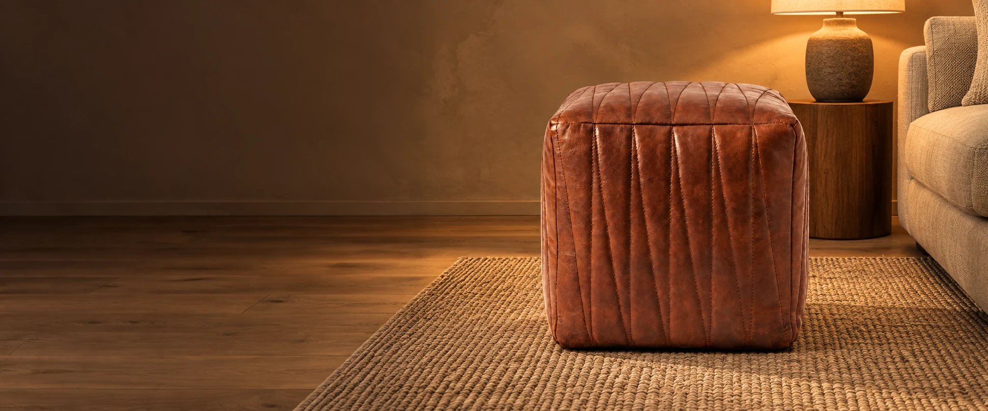 Square Leather Pouf Cover styled in a quiet living room with warm plaster walls and oak floors