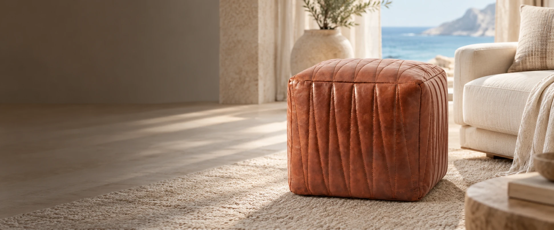 Square Leather Pouf Cover styled with an insert beside a sofa