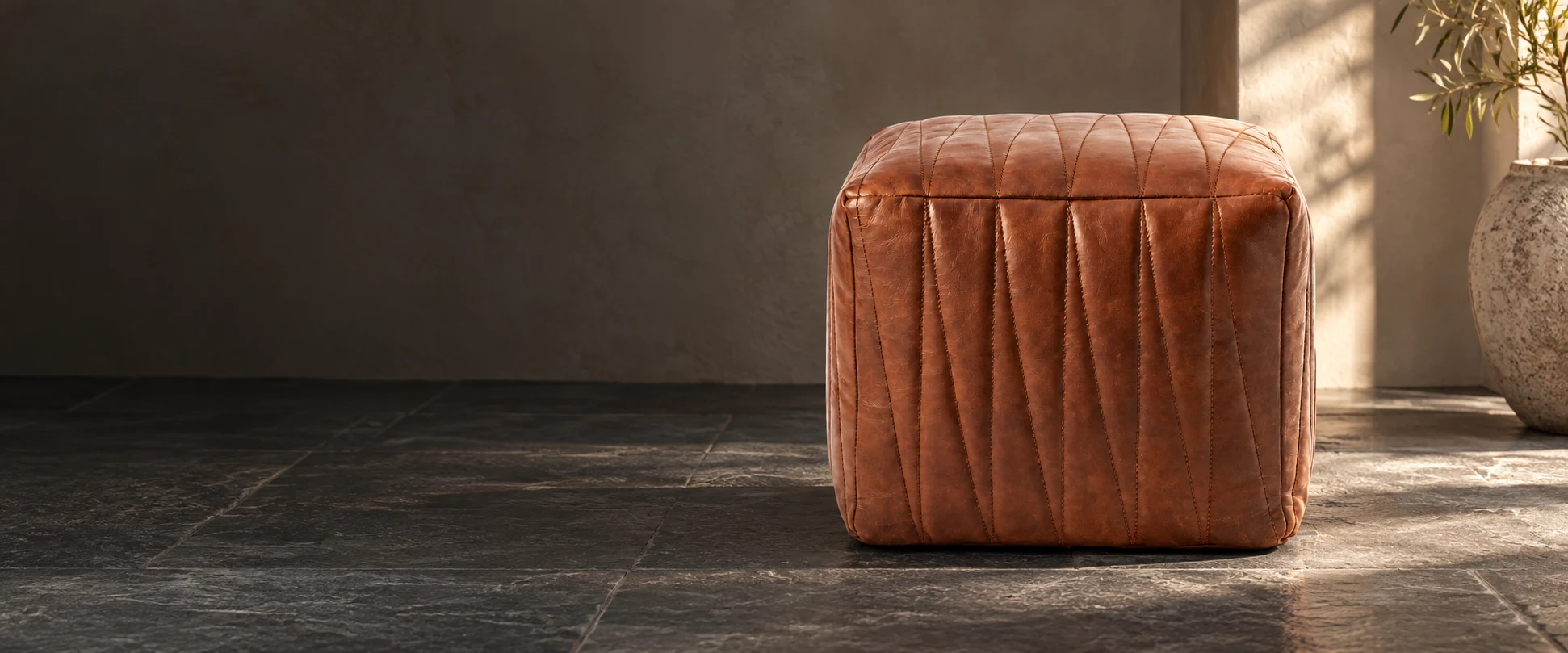 Square Leather Pouf Cover styled in an understated home studio with slate flooring