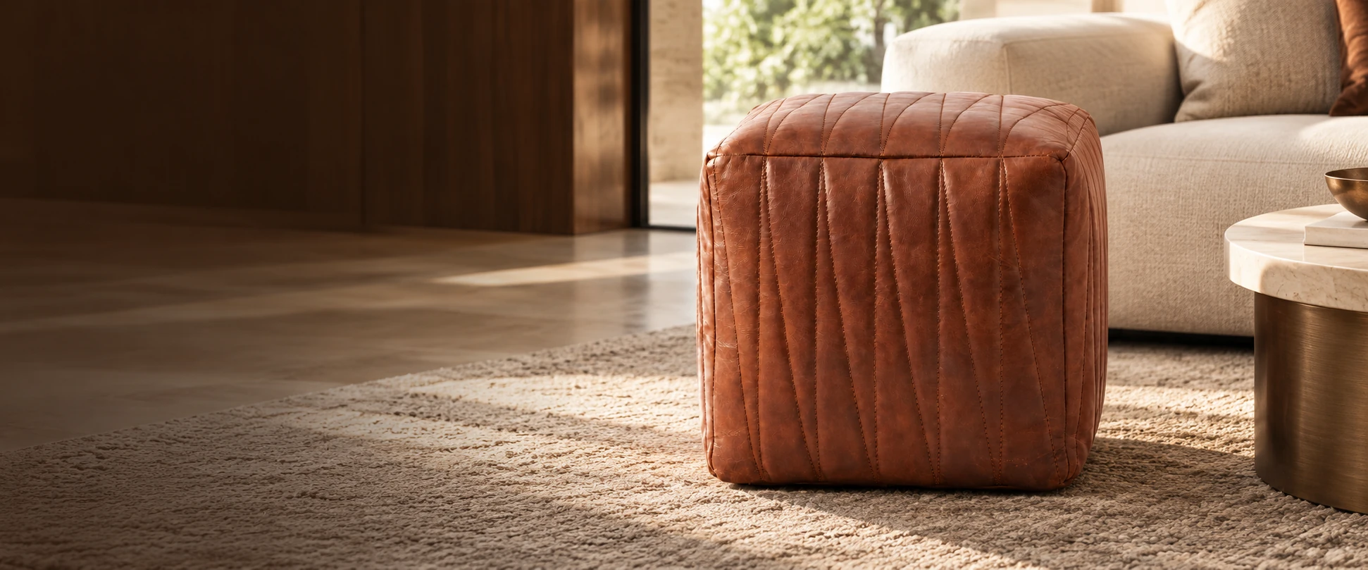 Square Leather Pouf Cover styled with an insert beside a sofa