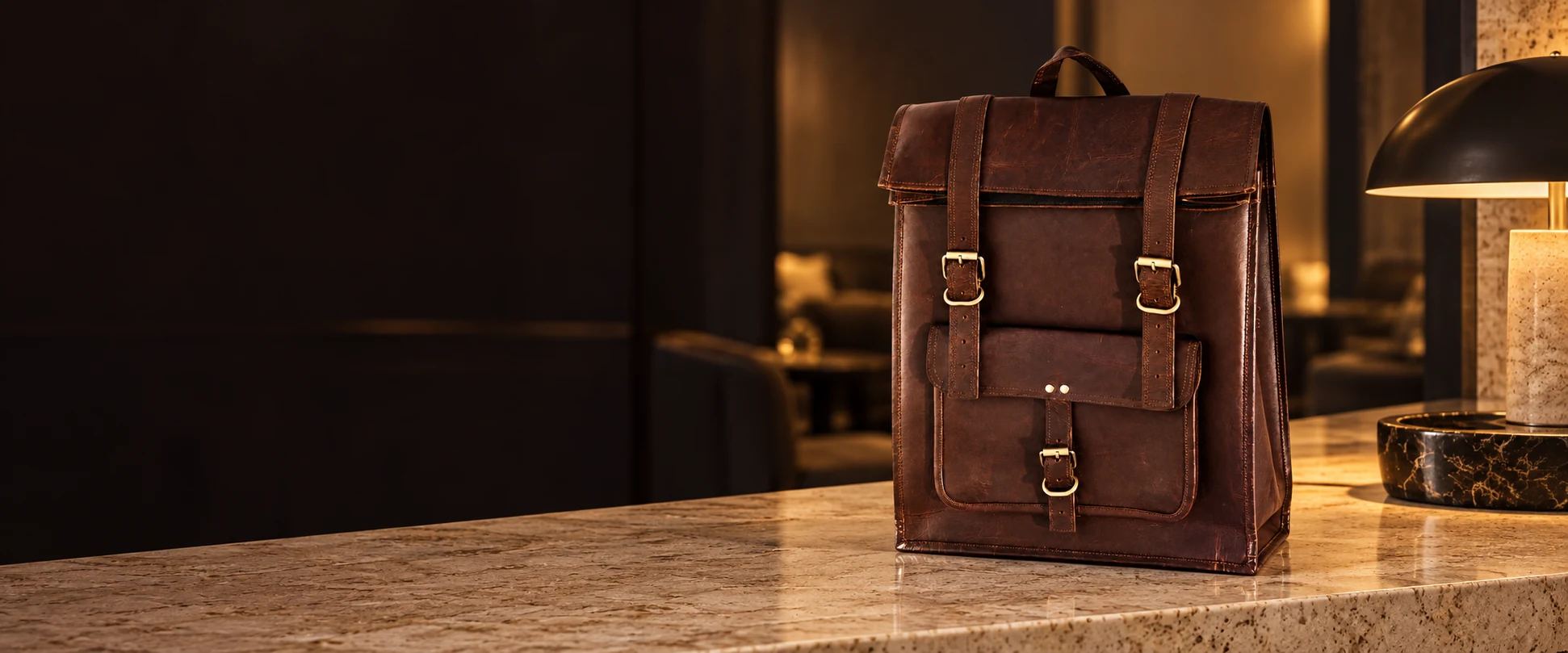 Leather Flap Backpack displayed on a travertine counter in a refined business lounge