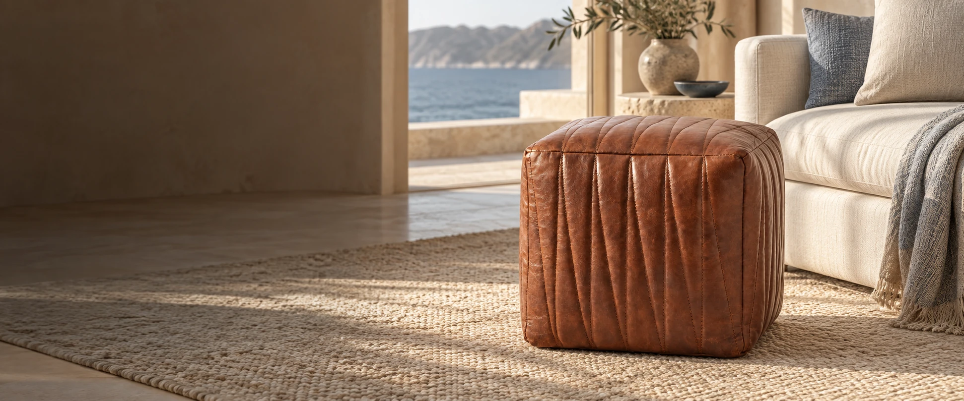 Square Leather Pouf Cover styled with an insert beside a sofa