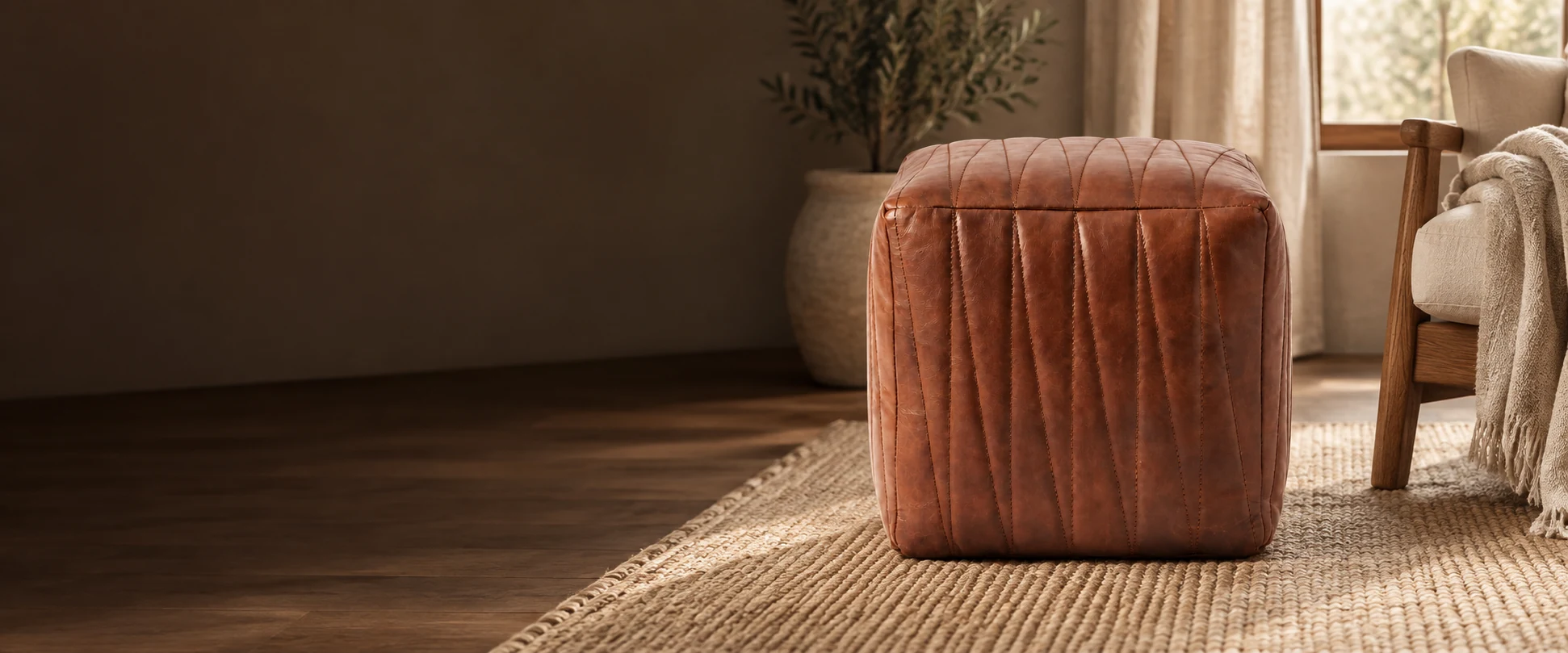 Square Leather Pouf Cover styled in a reading corner with neutral linen and warm timber